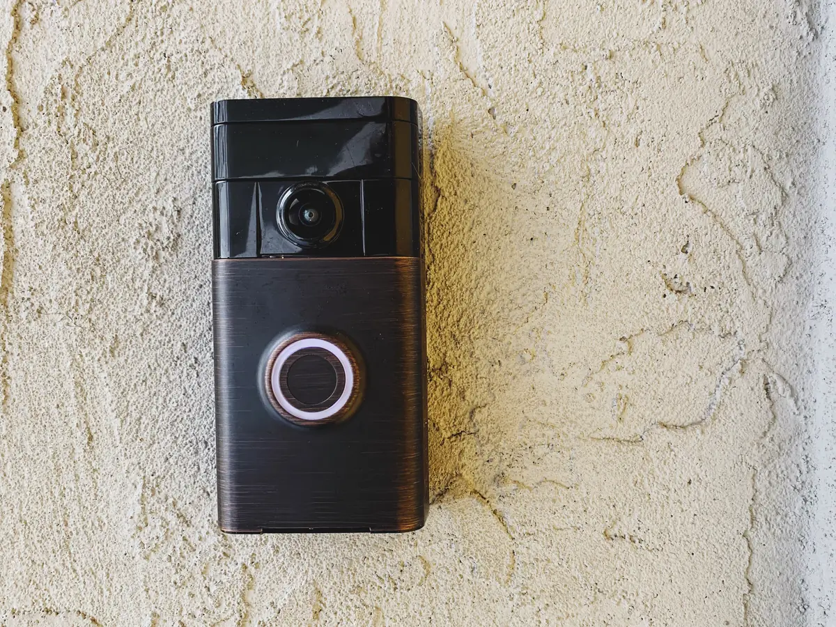 Video doorbell mounted on a stucco exterior wall